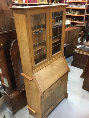 Lot 899 - Edwardian oak bureau bookcase with leaded stained glass doors to upper section, above fall flap, central draw and panelled doors enclosing shelved interior, 178 x 85 x 25cm