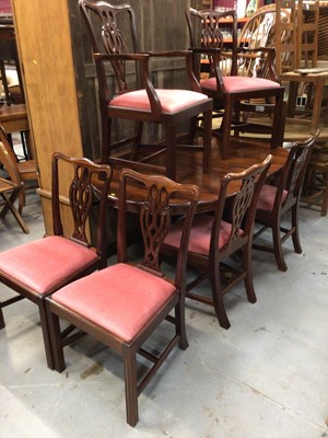 Lot 1024 - Georgian-style mahogany twin pedestal dining table, the D-shaped tops on turned pedestals and tripod bases terminating on brass capped castors, together with a set of six matching chairs with drop-...