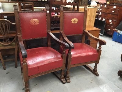 Lot 936 - Pair of impressive 1920s carved mahogany throne chairs with leather seats and gilt armorial crests