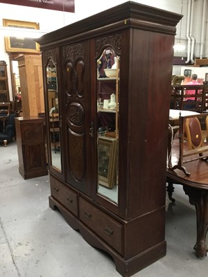 Lot 932 - Edwardian mahogany wardrobe with twin mirrored glass doors with carved decoration, central carved panel, above two draws.