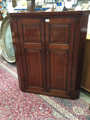 Lot 1036 - George III mahogany panelled corner cupboard