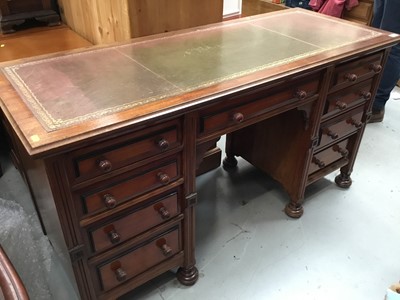 Lot 951 - Reproduction mahogany kneehole desk with lined top, nine drawers on bun feet 142 cm wide