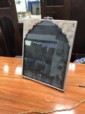 Lot 39 - Eastern white metal plated photograph frame with relief decoration, 26cm high