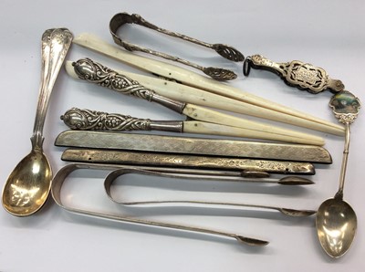 Lot 692 - Pair silver sugar tongs, silver souvenir spoon, pair silver handled glove stretchers, two silver comb mounts and other items