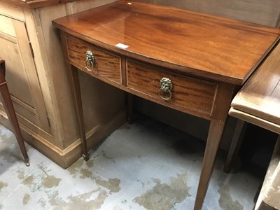 Lot 1002 - 19th century mahogany bowfront hall table with two drawers and brass lions head handles on taper legs and spade feet 76 cm wide