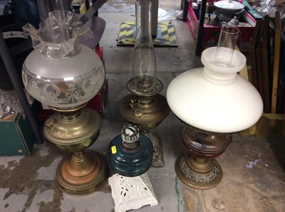 Lot 422 - Four various oil lamps including two brass lamps