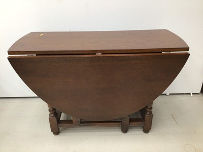 Lot 25 - Oak oval drop leaf dining table and a set of six oak wheelback chairs