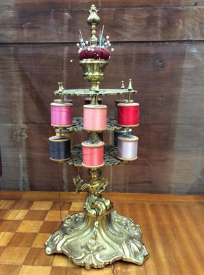 Lot 442 - Contemporary brass cotton reel holder with seated female figure column and pin cushion finial