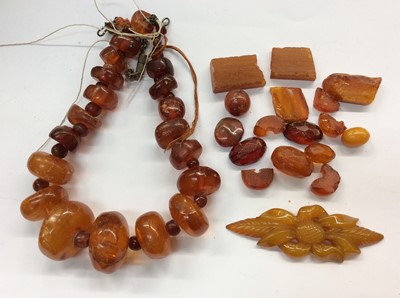 Lot 716 - Amber bead necklace, loose beads and carved amber panel