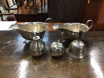 Lot 719 - Pair of Mappin & Webb silver sauceboats, two Eastern silver fruit-shape boxes, and a white metal bell, marks worn (5)