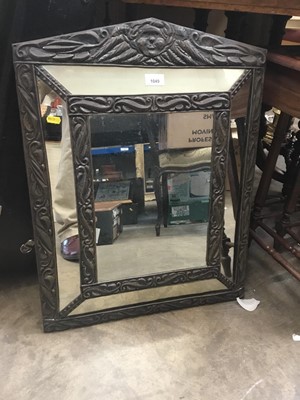Lot 1049 - Decorative embossed metal framed mirror with cherub decoration 66 x 52
