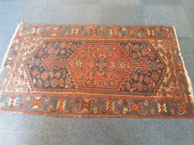 Lot 1068 - Two old Persian rugs with geometric decoration on red and blue ground, 175cm x 100 and 248cm x 101cm
