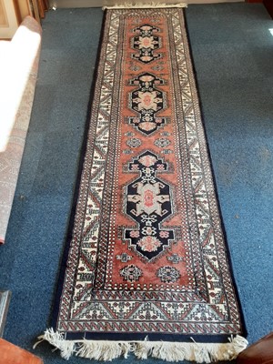 Lot 1071 - Eastern runner with geometric decoration on blue and cream ground, 292cm x 76cm