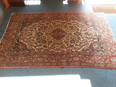 Lot 1074 - Eastern rug with geometric decoration on red, blue and cream ground, 212cm x 138cm