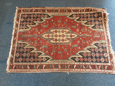 Lot 1076 - Eastern rug with geometric decoration on red and blue ground, 117cm x 87cm and one other beige rug, 128cm x 73cm