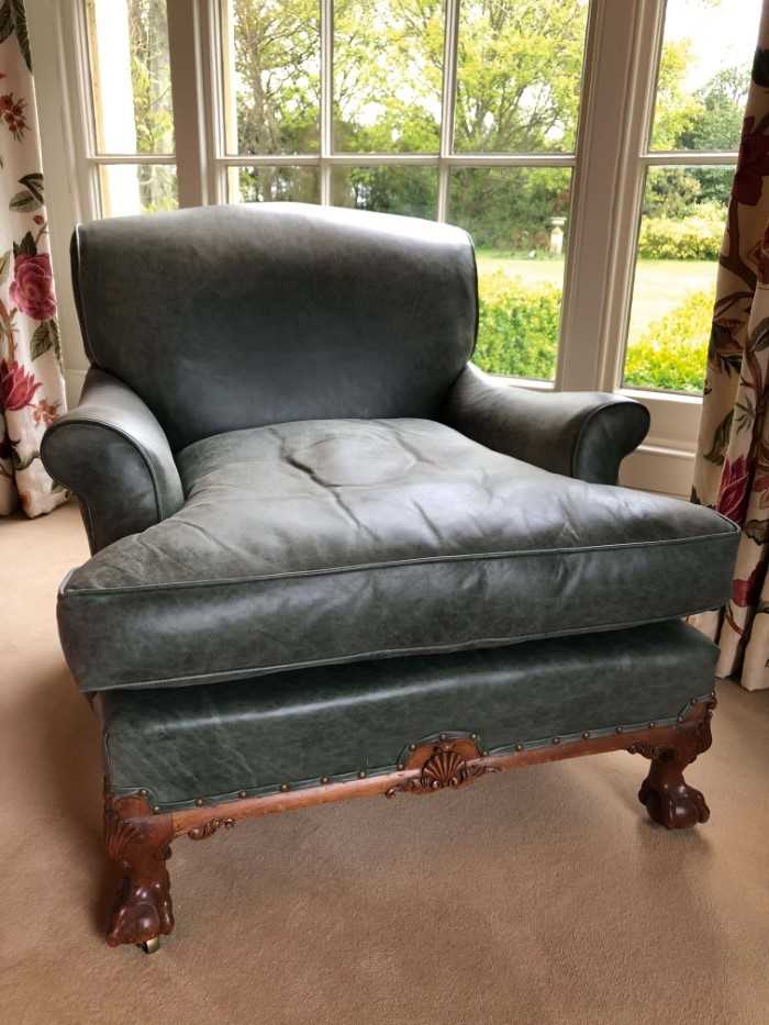 Lot 1415 - Good quality Howard & Sons low armchair, upholstered in blue/green leather with loose seat, on carved cabriole legs and claw and ball feet terminating on brass castors, the rear leg stamped 1238. 2...