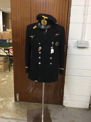 Lot 842 - A Postwar reproduction of a Nazi Naval Officers uniform, including hat, iron cross 1st class, metal eagle & medal bar, metal dog tags, all mounted on a dummy & stand.