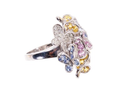 Lot 579 - Diamond and multi-coloured sapphire 'Butterfly' cluster cocktail ring with seven stylized butterflies, set with diamonds and pink, blue and yellow sapphires, all in 9ct white gold setting.