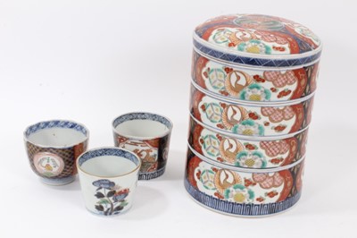 Lot 108 - Set of 19th century Japanese Meiji stacking boxes, together with three Imari cups