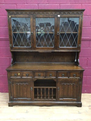 Lot 323 - Oak two height bookcase with leaded glazed doors above, drawers and linenfold panelled doors below, plus an oak bureau