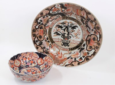 Lot 160 - A large Japanese Imari Charger, Edo period, 17th/18th century, the centre decorated with a vase of flowers, bordered by exotic birds and foliate patterns, 53.5cm diameter, together with a 19th cent...