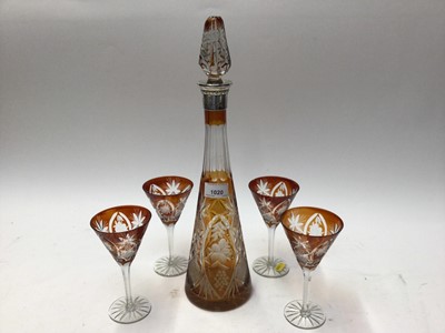 Lot 64 - Bohemian amber cut glass decanter and stopper, of tapered form with Continental white metal mount, together with four matching glasses (5)