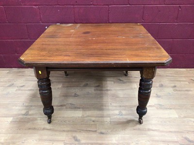 Lot 329 - Edwardian wind-out extending dining table with two extra leaves on turned legs terminating on ceramic castors