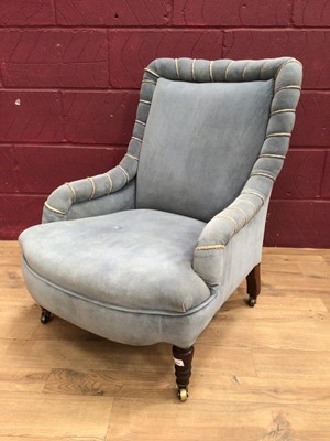 Lot 317 - Victorian easy chair upholstered in pale blue Drayson, on turned legs with brass castors.