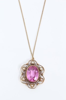 Lot 79 - Early 20th century 18ct gold pink stone and seed pearl pendant with an oval mixed cut pink stone, possibly a pink topaz, mounted in an open work flower shaped setting set with six seed pearls, on 1...