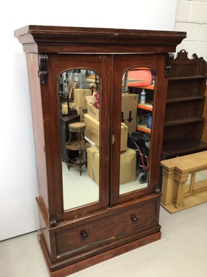 Lot 11 - Victorian mahogany double wardrobe with two arched mirror doors and drawer below, 127cm wide x 57cm deep x 211cm high
