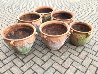 Lot 55 - Five similar terracotta garden urns with swag decorations approx 39cm height x 47cm diameter and a similar smaller terracotta urn 35cm height x 37cm diameter
