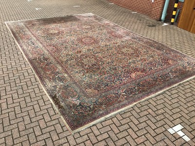 Lot 1560 - Large Persian carpet with geometric decoration on red, blue and cream ground 410cm x 630cm