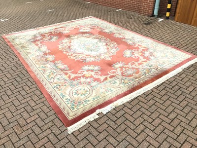 Lot 60 - Large Chinese was rug with floral decoration on terracotta and cream ground 367cm x 470cm