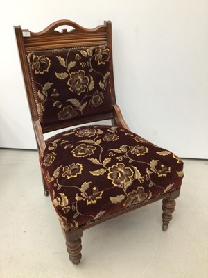 Lot 41 - Edwardian walnut framed easy chair with upholstered seat and back on turned front legs and castors