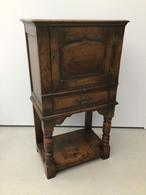 Lot 90 - Antique style oak cupboard with panelled door, draw below on turned front supports with under tier 62cm wide x 41cm deep x 114cm high