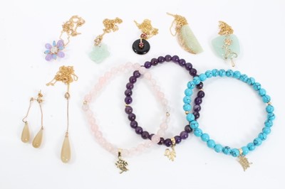 Lot 86 - Six 9ct gold mounted hard stone pendants on 9ct gold chains, one with matching pair earrings and three semi precious bead bracelets, each with a gold Chinese character mark charm