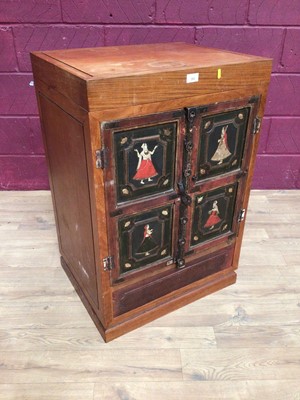 Lot 353 - Eastern camphor wood cabinet with rising hinged lid, two painted panelled doors below depicting Indian figures, 61cm wide, 48.5cm deep, 90cm high