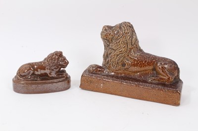 Lot 192 - 19th century salt glazed stoneware pottery door stop in the form of a lion, 18.5cm wide x 12.5cm high, and a further salt glazed model of a lion (2)