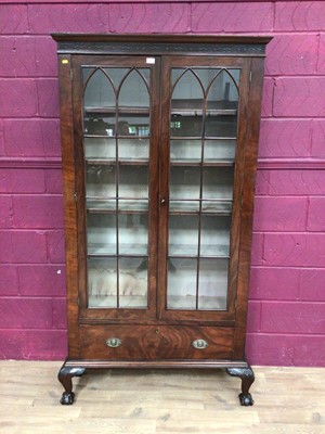 Lot 389 - Edwardian mahogany bookcase with shelved interior enclosed by two glazed doors with drawer below on carved cabriole legs with claw and ball feet, 106.5cm wide, 34cm deep, 200.5cm high