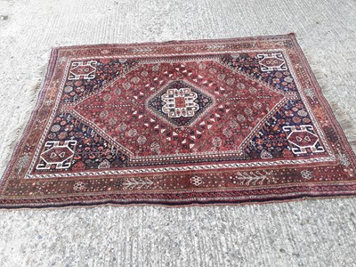 Lot 394 - Eastern rug with geometric decoration on red and blue ground, 199cm x 148cm
