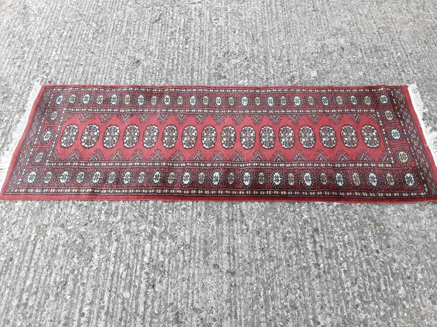 Lot 396 - Eastern runner with geometric decoration, 184cm x 64cm
