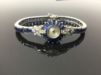 Lot 533 - 1950s/1960s ladies Omega diamond and sapphire cocktail wristwatch, the circular dial with concealed winding crown, tapered baguette cut sapphires and diamond lugs with marquise and brilliant cut di...