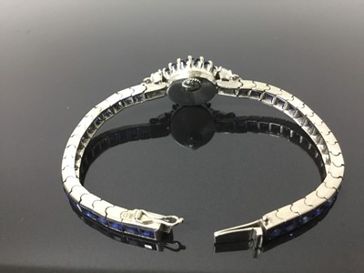 Lot 533 - 1950s/1960s ladies Omega diamond and sapphire cocktail wristwatch, the circular dial with concealed winding crown, tapered baguette cut sapphires and diamond lugs with marquise and brilliant cut di...