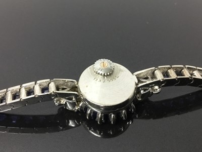 Lot 533 - 1950s/1960s ladies Omega diamond and sapphire cocktail wristwatch, the circular dial with concealed winding crown, tapered baguette cut sapphires and diamond lugs with marquise and brilliant cut di...