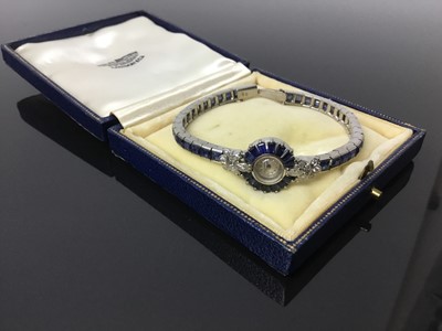 Lot 533 - 1950s/1960s ladies Omega diamond and sapphire cocktail wristwatch, the circular dial with concealed winding crown, tapered baguette cut sapphires and diamond lugs with marquise and brilliant cut di...