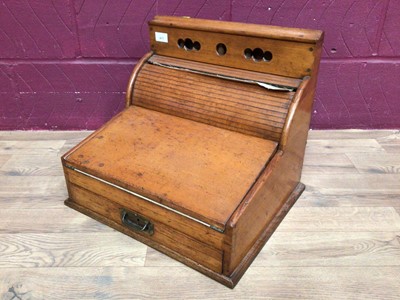 Lot 411 - 1920's oak stationery desk cabinet with tambour front, fold out leather lined writing slope and drawer below