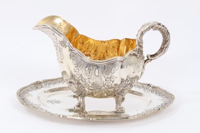 Lot 33 - Late 19th/early 20th Century German Silver Sauce Boat, from the Royal Prussian Collection, of oval form with reeded border, repousse and chased with rocaille, flowers and foliage, with bifurcated f...
