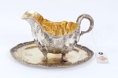 Lot 36 - Late 19th Century German Silver Sauce Boat, from the Royal Prussian Collection, of oval form with reeded border, repousse and chased with rocaille, flowers and foliage, with bifurcated foliage-capp...