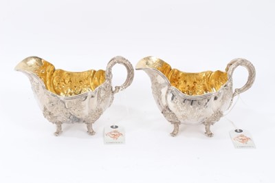 Lot 38 - Two Late 19th Century German Silver Sauce Boats of oval form, from the Royal Prussian Collection, with reeded border, repousse and chased with rocaille, flowers and foliage, with bifurcated foliage...