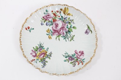 Lot 247 - Bow porcelain dish, c.1760, of fluted form, polychrome painted with flowers, 20cm diameter